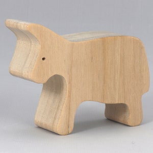 Handmade and unfinished, this wooden toy cow cutout is perfect for those who love to paint and customize their toys. It is freestanding and stackable, making it a versatile addition to any playroom or nursery. From My Itty Bitty Animal Collection
