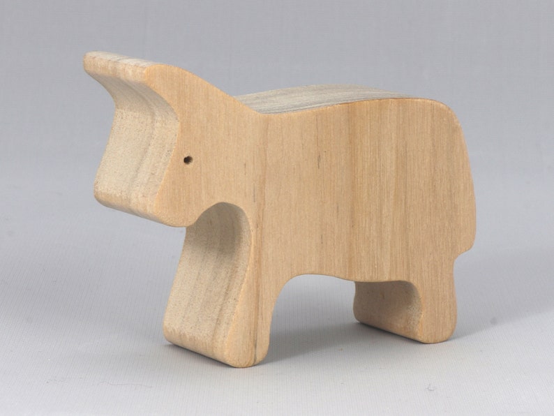 Handmade and unfinished, this wooden toy cow cutout is perfect for those who love to paint and customize their toys. It is freestanding and stackable, making it a versatile addition to any playroom or nursery. From My Itty Bitty Animal Collection