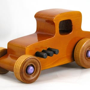 Handmade wooden toy car '27 T-Coupe, finished with amber shellac, metallic purple, and black acrylic paint. Made to order.
