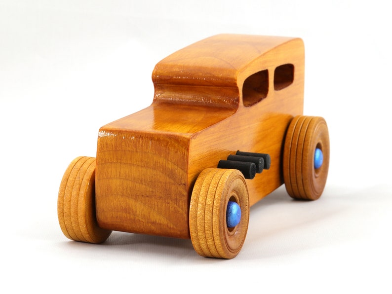Handcrafted wooden hot rod toy car modeled after a classic '32 sedan. Finished with amber shellac and adorned with metallic sapphire blue and black trim. This unique piece is part of my Hot Rod Collection.