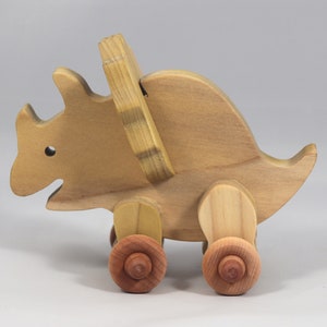 Handmade wooden push toy Triceratops dinosaur made from select grade hardwoods and finished with a non-toxic coating.