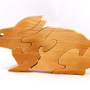 A wooden four piece puzzle in the shape of a rabbit. Perfect toddlers first puzzle.