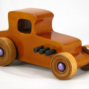 Handmade wooden toy car '27 T-Coupe, finished with amber shellac, metallic purple, and black acrylic paint. Made to order.