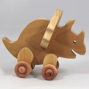 Handmade wooden push toy Triceratops dinosaur made from select grade hardwoods and finished with a non-toxic coating.
