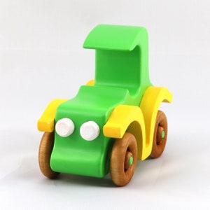 Handmade wooden toy car, vintage-style Model T sedan, painted bright green and yellow with spoked wheels, finished in amber shellac.  Handcrafted in Tallahassee, Florida, USA by Odin's Toy Factory.