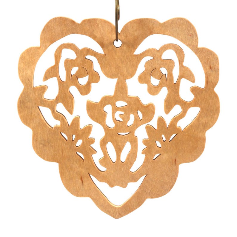 A handmade wooden Victorian-style fretwork floral heart Christmas tree ornament, featuring intricate cutout floral patterns in a heart shape, with a warm natural wood finish.