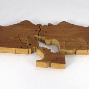 Wooden 6-piece bison family puzzle with two adult bison and four calves. The hardwood pieces interlock into one standing group or separate to stand alone. Handnmade in Tallahassee, Florida, USA by Odin's Toy Factory.