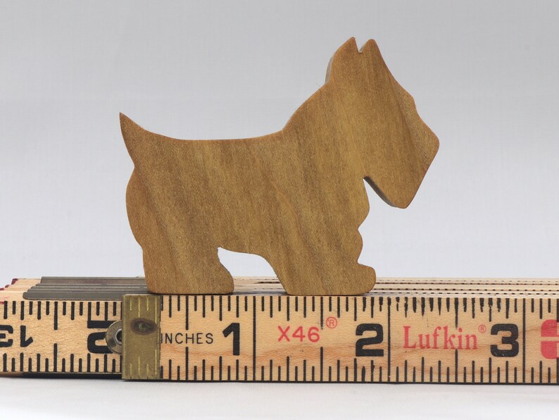 Handmade wooden Scottie dog toy cutout finished with mineral oil and beeswax blend. Freestanding stackable design from my Itty Bitty Animal Collection. Handcrafted in Tallahassee, Florida, USA from quality hardwood. Approximate size: length 2-1/2 inches, height 2 inches, width 3/4 inch. Each piece is unique with natural wood grain variations.