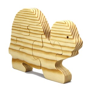 Handmade wooden turtle puzzle with 5 simple interlocking pieces. Freestanding 5-piece wooden puzzle. Approximate dimensions: 5 inches high by 7.25 inches long by 0.75 inches thick. Finished with mineral oil and beeswax blend. Handcrafted in Tallahassee, Florida, USA, using natural wood. Unique wood grain color and knot variations. Odin’s Toy Factory.