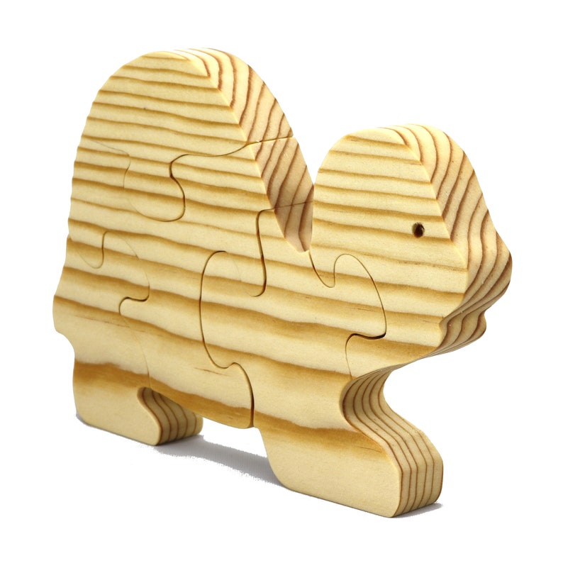 Handmade wooden turtle puzzle with 5 simple interlocking pieces. Freestanding 5-piece wooden puzzle. Approximate dimensions: 5 inches high by 7.25 inches long by 0.75 inches thick. Finished with mineral oil and beeswax blend. Handcrafted in Tallahassee, Florida, USA, using natural wood. Unique wood grain color and knot variations. Odin’s Toy Factory.