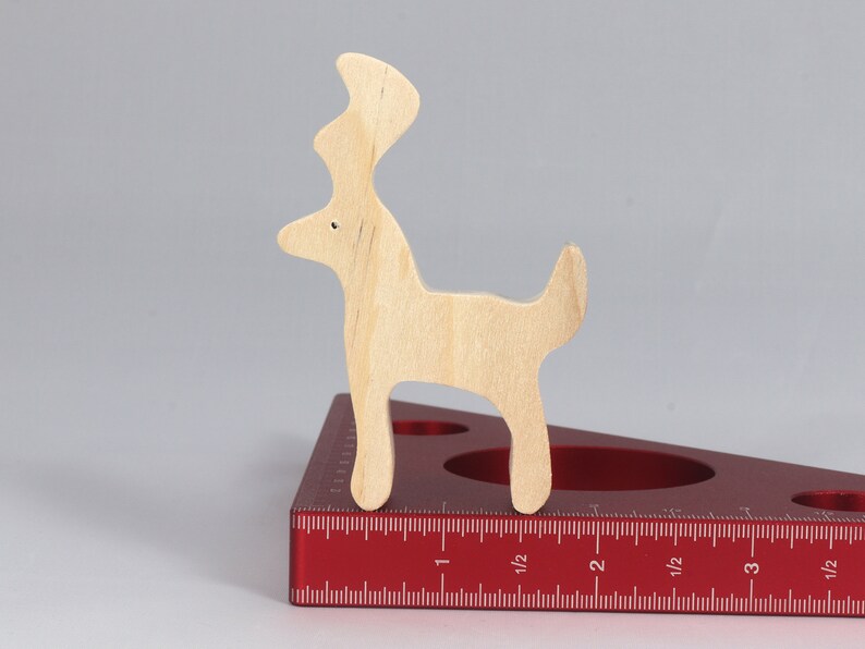 Handmade unfinished wooden deer toy figurine, part of the Itty Bitty Animal Collection, shown in natural light wood with visible grain, standing on a white background.