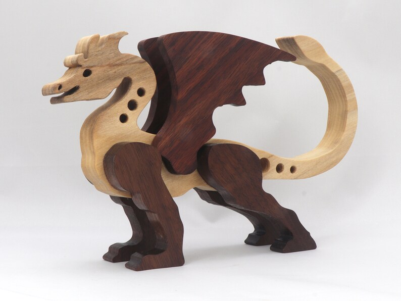 Handmade wood dragon figurine made from select grade contrasting hardwoods and hand-finished with a custom mixture of mineral oil and waxes.