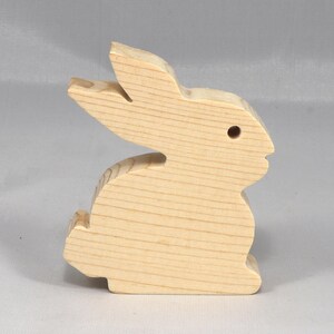 This is an unfinished wooden Rabbit cutout from solid wood using traditional woodworking techniques. Sanded smooth and ready to paint, stain, or customize. Freestanding design for small hands, toddlers, young children, crafters, collectors, and display. I take custom orders for any animal, quantity, and mix — including large ornament orders. Mix and match, request a different size, or send a drawing or pattern. Handmade by Odin's Toy Factory in Tallahassee, Florida, USA.