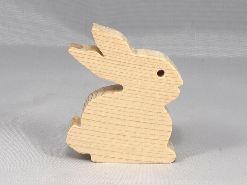 This is an unfinished wooden Rabbit cutout from solid wood using traditional woodworking techniques. Sanded smooth and ready to paint, stain, or customize. Freestanding design for small hands, toddlers, young children, crafters, collectors, and display. I take custom orders for any animal, quantity, and mix — including large ornament orders. Mix and match, request a different size, or send a drawing or pattern. Handmade by Odin's Toy Factory in Tallahassee, Florida, USA.