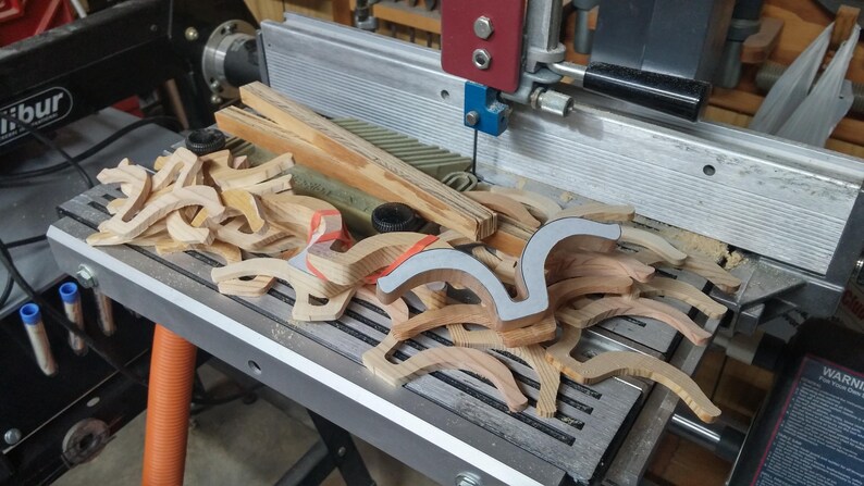 Odin' Toy Factory Toymakers Shop Photo - A collection of unfinished wooden fenders on my Shopsmith bandsaw. The original fenders were to thick and hade to resawn.