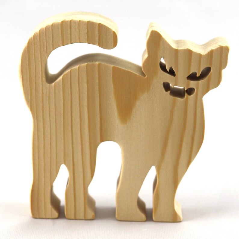 Handmade unfinished wooden Halloween cat cutout by Odin's Toy Factory. Freestanding cat figure cut from 3/4 inch thick wood and ready to paint. Approximate size 3.5 inches height by 3.5 inches width by 0.75 inches thick. Hand-cut solid wood Halloween decoration for crafts, toys, ornaments, and display. Custom orders available. Made in Tallahassee, Florida, USA.