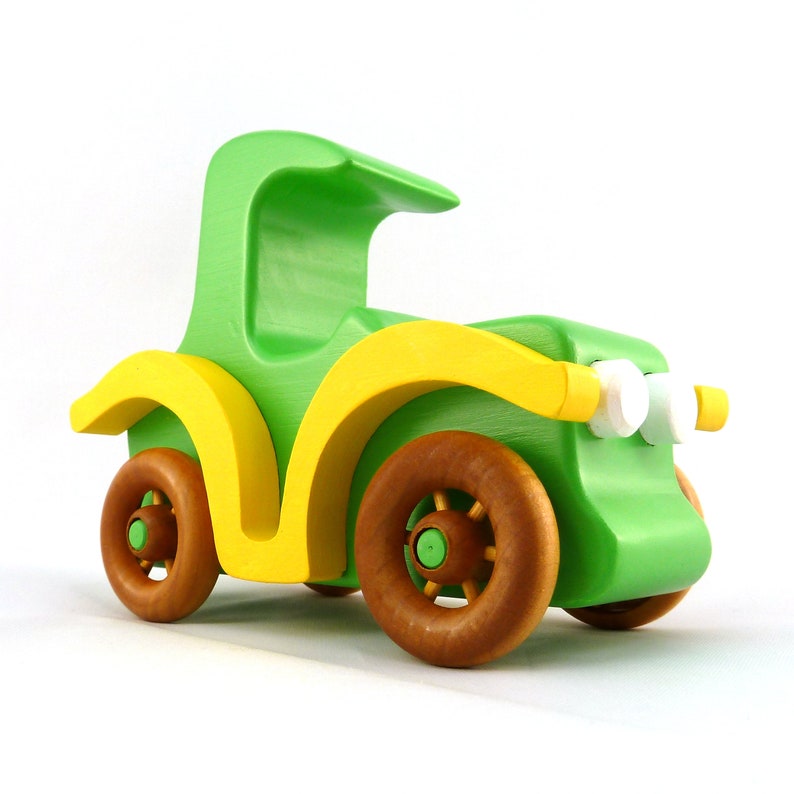 Handmade wooden toy car, vintage-style Model T sedan, painted bright green and yellow with spoked wheels, finished in amber shellac.  Handcrafted in Tallahassee, Florida, USA by Odin's Toy Factory.
