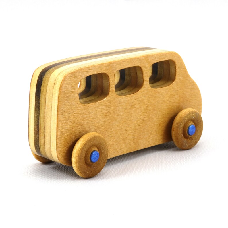 Handmade wood toy minivan made by me in my shop using traditional woodworking tools. It is hand finished with clear shellac with metallic sapphire blue acrylic paint.