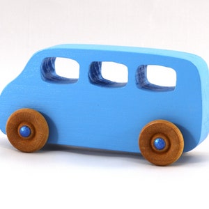 A Handmade wood toy mini van hand-painted baby blue with metallic sapphire blue trim and wheels finished with nonmarring amber shellac from my Play Pall Collection.