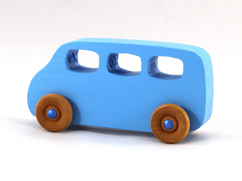 A Handmade wood toy mini van hand-painted baby blue with metallic sapphire blue trim and wheels finished with nonmarring amber shellac from my Play Pall Collection.