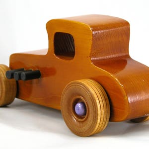 Handmade wooden toy car '27 T-Coupe, finished with amber shellac, metallic purple, and black acrylic paint. Made to order.