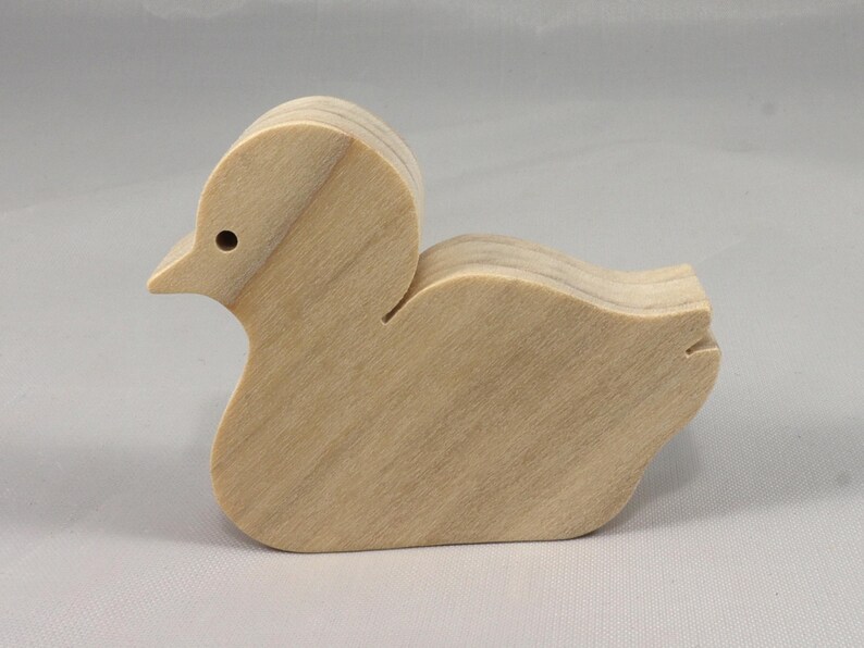 This is an unfinished wooden Duck cutout from solid wood using traditional woodworking techniques. Sanded smooth and ready to paint, stain, or customize. Freestanding design for small hands, toddlers, young children, crafters, collectors, and display. I take custom orders for any animal, quantity, and mix — including large ornament orders. Mix and match, request a different size, or send a drawing or pattern. Handmade by Odin's Toy Factory in Tallahassee, Florida, USA.