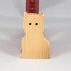 A handmade freestanding wooden toy cat cutout 1/2-3/4 inches thick is made from various kinds of wood sanded smooth and ready to paint. It is excellent for kids' crafts, pretend, or stacking toys. Other sizes are available with a custom order.