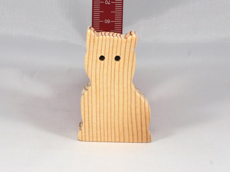 A handmade freestanding wooden toy cat cutout 1/2-3/4 inches thick is made from various kinds of wood sanded smooth and ready to paint. It is excellent for kids' crafts, pretend, or stacking toys. Other sizes are available with a custom order.