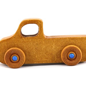 This handmade toy pickup truck from My Play Pal Collection is finished with amber shellac and metallic sapphire blue acrylic paint. It is just one of many unique wooden vehicles available.