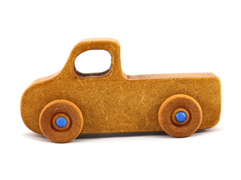 This handmade toy pickup truck from My Play Pal Collection is finished with amber shellac and metallic sapphire blue acrylic paint. It is just one of many unique wooden vehicles available.