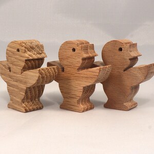 This is an unfinished wooden Singing Bird cutout from solid wood using traditional woodworking techniques. Sanded smooth and ready to paint, stain, or customize. Freestanding design for small hands, toddlers, young children, crafters, collectors, and display. I take custom orders for any animal, quantity, and mix — including large ornament orders. Mix and match, request a different size, or send a drawing or pattern. Handmade by Odin's Toy Factory in Tallahassee, Florida, USA.