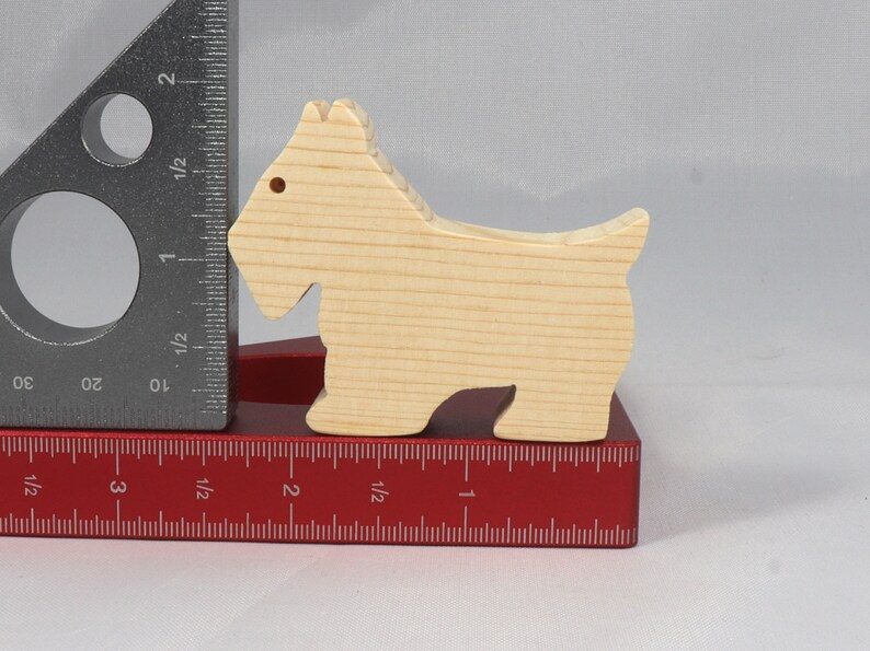 Handmade wood toy Scottie dog cutout unfinished unpainted paintable freestanding Itty Bitty Animal Collection. Approximate size 2.5 inches length by 2 inches height by 0.75 inches width. Handmade in Tallahassee Florida USA from natural wood offcuts.