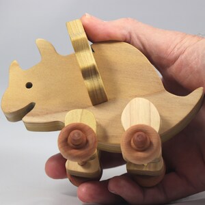 Handmade wooden push toy Triceratops dinosaur made from select grade hardwoods and finished with a non-toxic coating.
