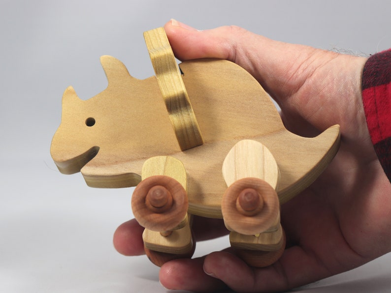 Handmade wooden push toy Triceratops dinosaur made from select grade hardwoods and finished with a non-toxic coating.