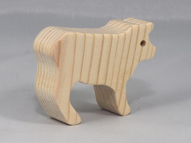This is an unfinished wooden Calf cutout from solid wood using traditional woodworking techniques. Sanded smooth and ready to paint, stain, or customize. Freestanding design for small hands, toddlers, young children, crafters, collectors, and display. I take custom orders for any animal, quantity, and mix — including large ornament orders. Mix and match, request a different size, or send a drawing or pattern. Handmade by Odin's Toy Factory in Tallahassee, Florida, USA.