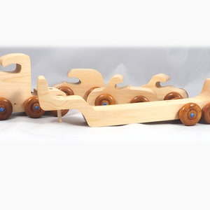 Handmade wooden toy truck play set includes three cars and a tractor-trailer finished with clear and amber shellac with metallic sapphire blue trim.