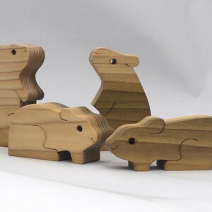 Handmade Wooden Stacking Puzzle Guinea Pig Family, Mom, and Babies finished with a non-toxic custom blend of mineral oil and waxes. This wooden toy animal is perfect for imaginative play and an excellent gift for children.