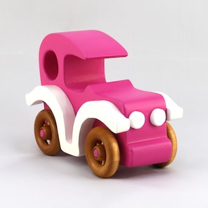 Handmade wooden toy car model-t sedan finished with hot pink and white acrylic paint with nonmaring amber shellac coated spoked wheels from my Bad Bob'S Custom Motors Collection.