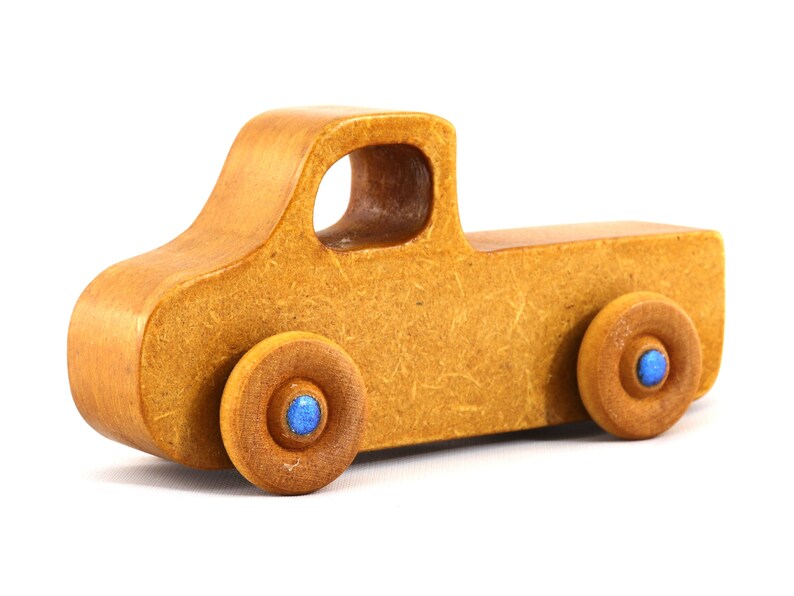This handmade toy pickup truck from My Play Pal Collection is finished with amber shellac and metallic sapphire blue acrylic paint. It is just one of many unique wooden vehicles available.