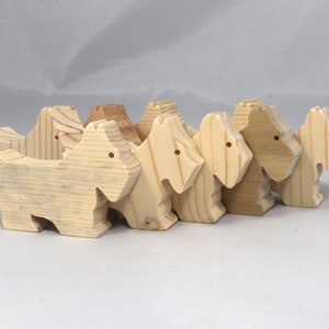 Handmade wood toy Scottie dog cutout unfinished unpainted paintable freestanding Itty Bitty Animal Collection. Approximate size 2.5 inches length by 2 inches height by 0.75 inches width. Handmade in Tallahassee Florida USA from natural wood offcuts.