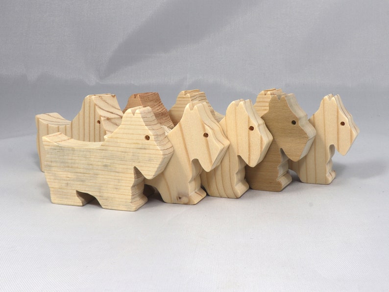 Handmade wood toy Scottie dog cutout unfinished unpainted paintable freestanding Itty Bitty Animal Collection. Approximate size 2.5 inches length by 2 inches height by 0.75 inches width. Handmade in Tallahassee Florida USA from natural wood offcuts.