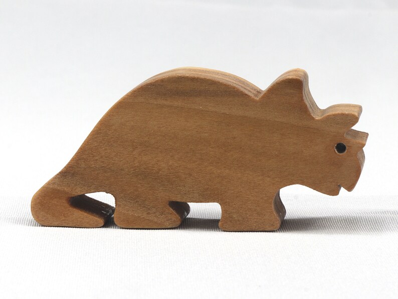 This small wooden triceratops dinosaur toy is crafted from high-quality hardwood and hand-finished. It is a delightful plaything for young children and appeals to many adults.