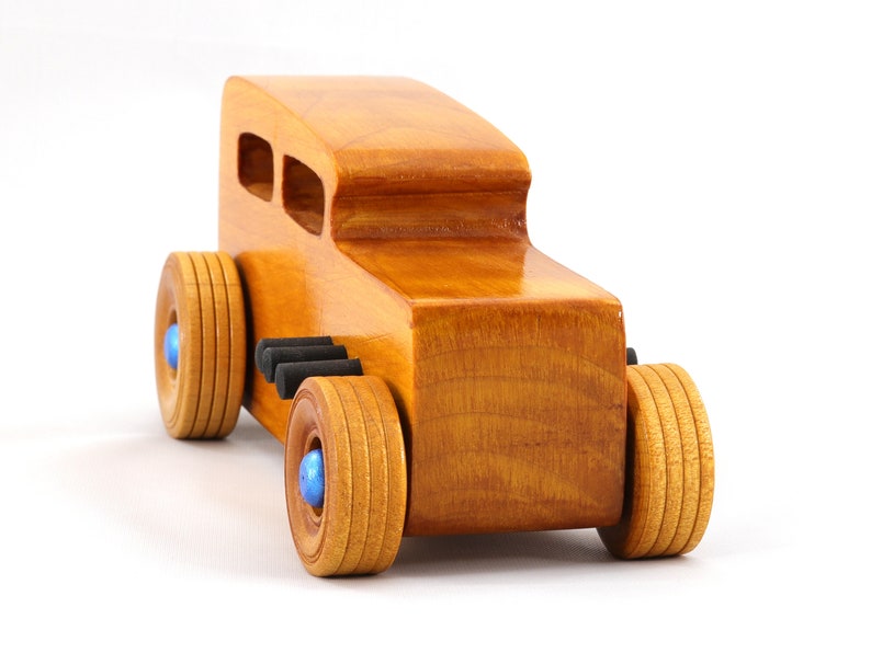 Handcrafted wooden hot rod toy car modeled after a classic '32 sedan. Finished with amber shellac and adorned with metallic sapphire blue and black trim. This unique piece is part of my Hot Rod Collection.