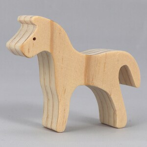 Handmade wooden toy horse cutout, perfect for children's playtime collection. Freestanding and stackable, ready to paint or customize. Endless possibilities for imaginative play, from farm scenes to towering animal creations.
