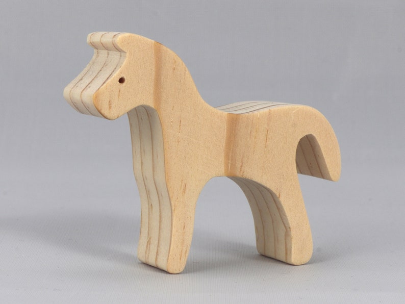 Handmade wooden toy horse cutout, perfect for children's playtime collection. Freestanding and stackable, ready to paint or customize. Endless possibilities for imaginative play, from farm scenes to towering animal creations.