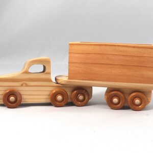 Handmade wooden toy tractor trailer semi truck finished with clear shellac. Crafted from natural wood using traditional woodworking tools. Approximate size 7 inches long. Made in Tallahassee, Florida, USA from Odin's Toy Factory Play Pal Collection.