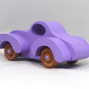 A Handmade Wood Toy Car Fat Fendered Coupe Hand Painted With Amethyst Acrylic Paint And Amber Shellac