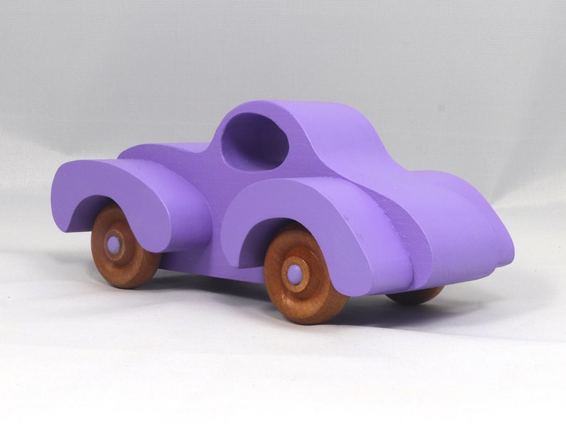 A Handmade Wood Toy Car Fat Fendered Coupe Hand Painted With Amethyst Acrylic Paint And Amber Shellac