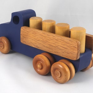 This handmade wooden Lorry truck is finished with navy blue acrylic paint and Amber Shellac. It is one of five towable trucks in this collection, available in many colors and unfinished. Custom Orders are welcome.