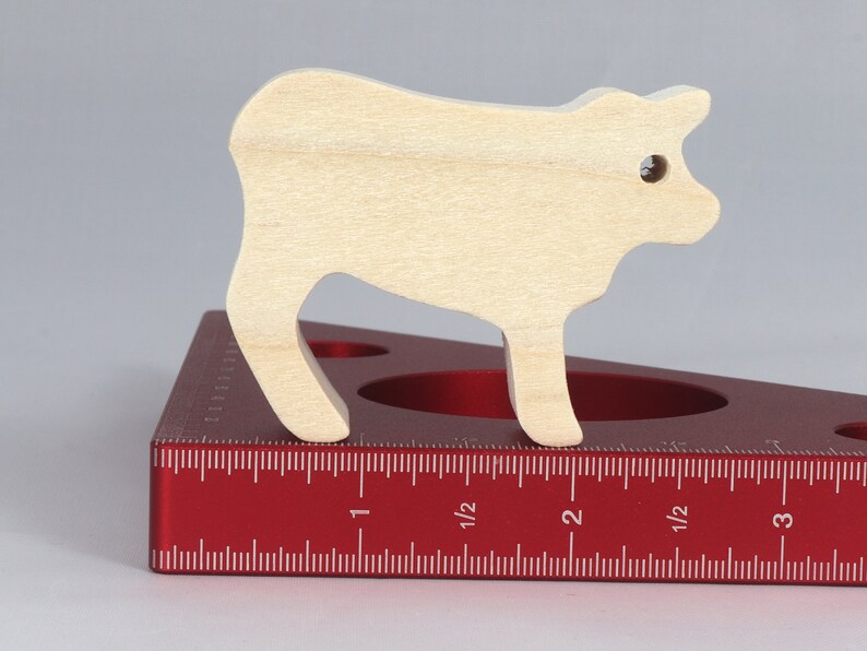 Handmade unfinished wooden toy baby calf cutout, unpainted and ready to paint, freestanding farm animal figure from Odin's Toy Factory’s  Itty Bitty Animal Collection. Handcrafted in Tallahassee, Florida, USA, using reclaimed natural wood offcuts. Perfect for imaginative play, stacking, collectors, and crafting.
